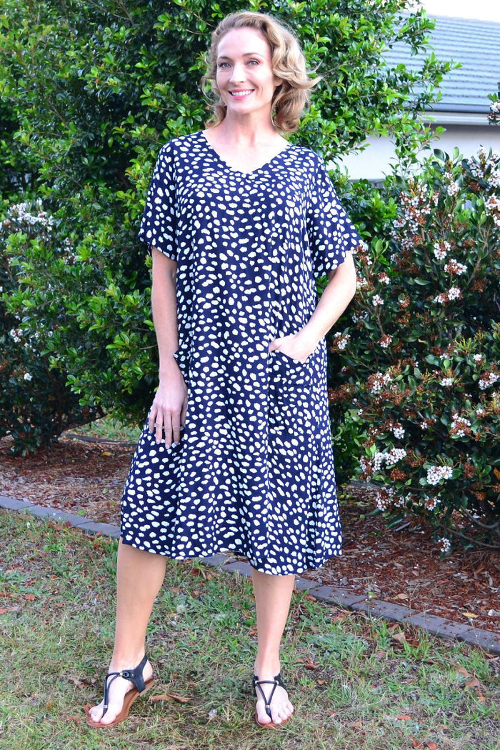 Navy dots and pockets tunic slip dress by Sunshine, featuring a relaxed fit, sleeveless design, and side pockets.