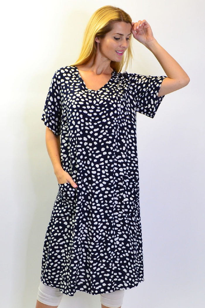 Navy dots and pockets tunic slip dress by Sunshine with a relaxed fit, featuring side pockets and a stylish dot pattern.