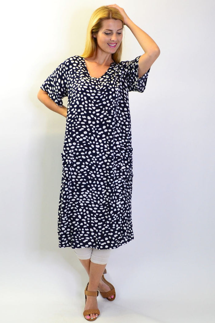 Navy dots and pockets tunic slip dress by Sunshine, featuring a sleeveless design with side pockets, styled for casual wear.