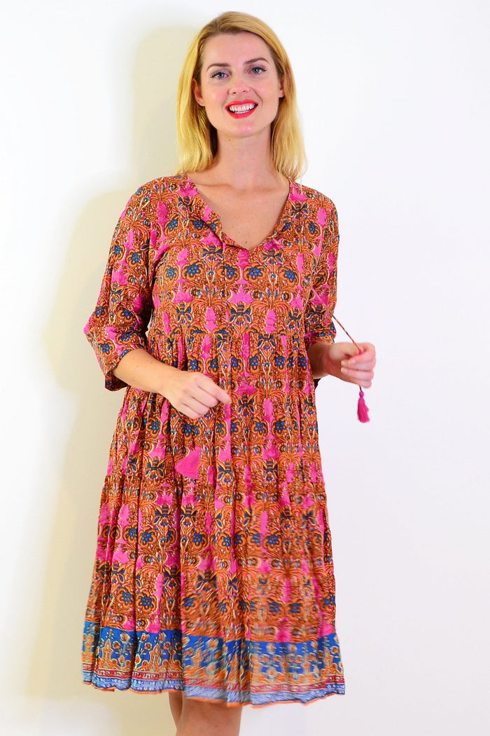 Orange and pink Rebecca tie neck tunic dress by One Summer, shown on a model with a relaxed fit and vibrant color pattern.