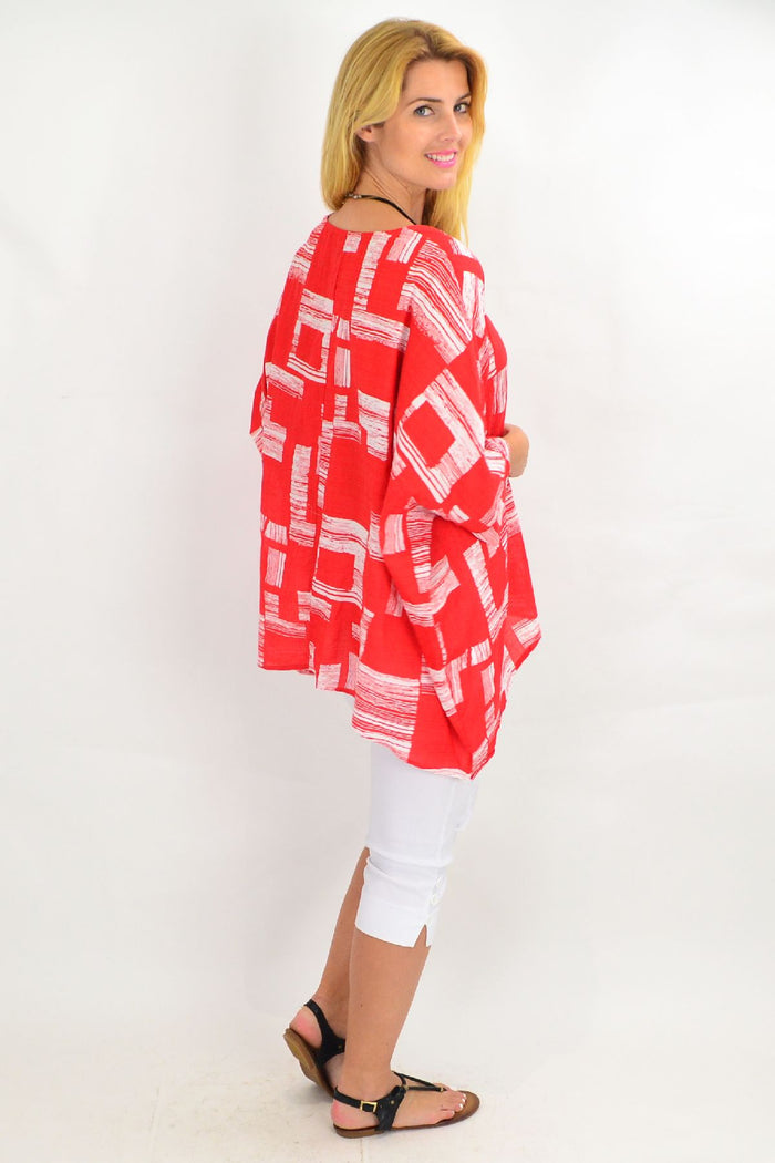 Orange-red and white block tunic top by Missy Q, featuring a stylish, casual design with bold color blocking and a relaxed fit.