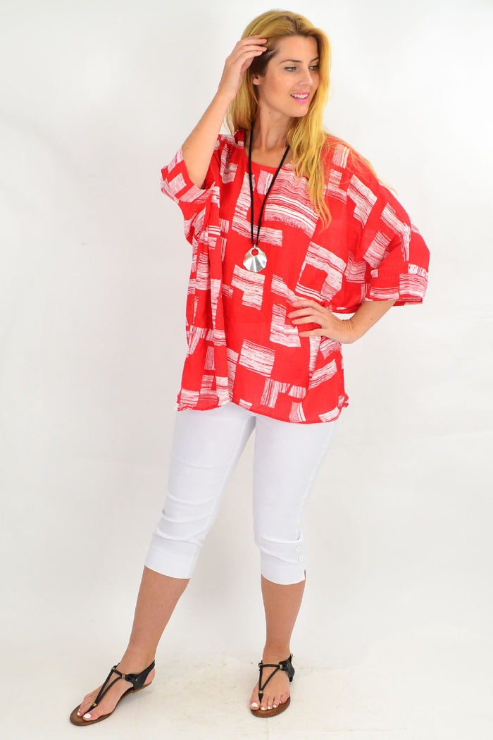 Orange-red and white block tunic top by Missy Q, featuring a relaxed fit and stylish color blocking.
