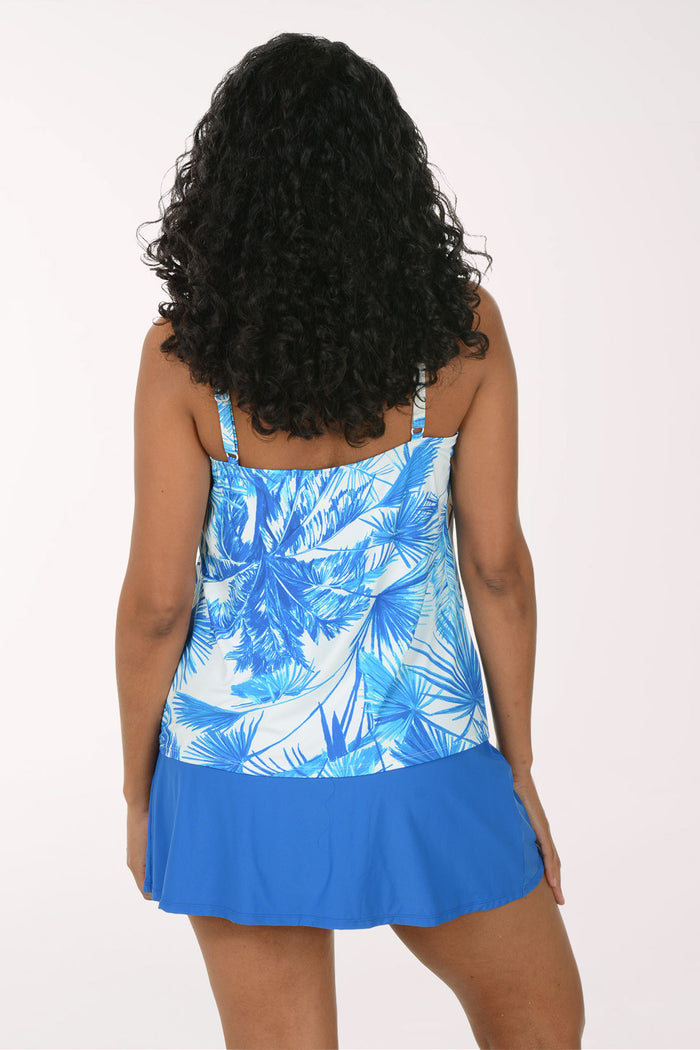 Woman wearing a blue floral tank top and skirt on a white background