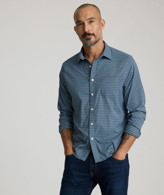 Model is wearing UNTUCKit Delune performance shirt in green check.