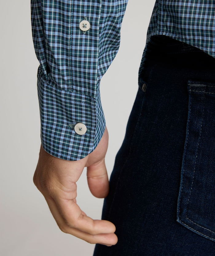 Model is wearing UNTUCKit Delune performance shirt in green check.