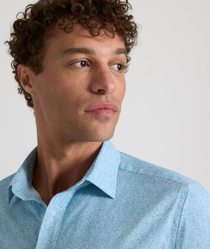 Model is wearing UNTUCKit Bell shirt in light blue floral print.