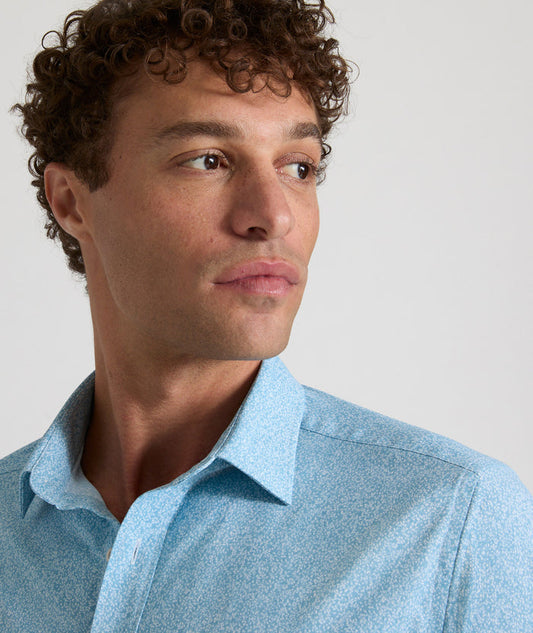 Model is wearing UNTUCKit Bell shirt in light blue floral print.