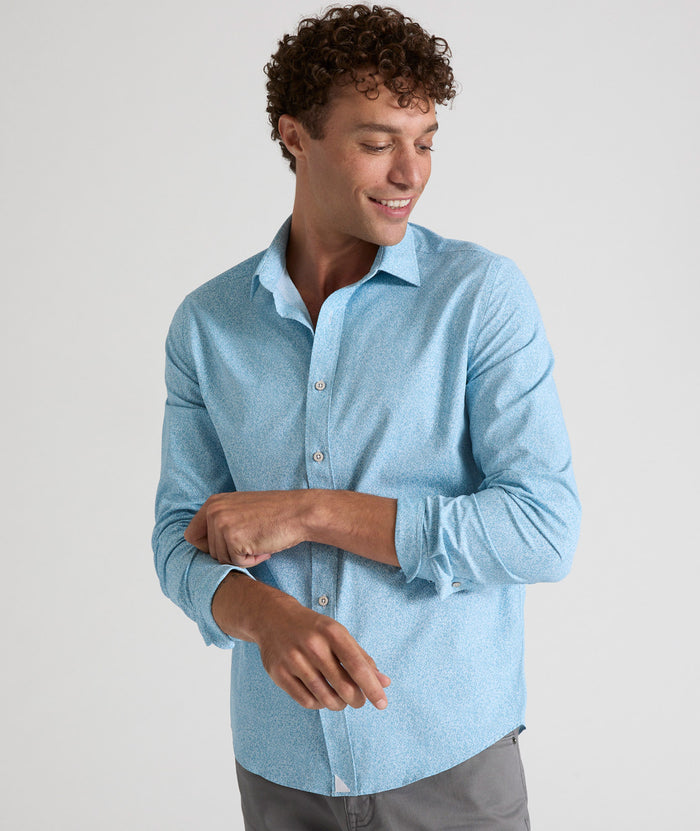 Model is wearing UNTUCKit Bell shirt in light blue floral print.