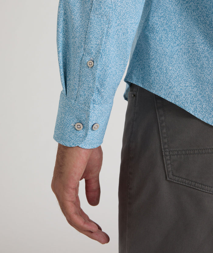 Model is wearing UNTUCKit Bell shirt in light blue floral print.