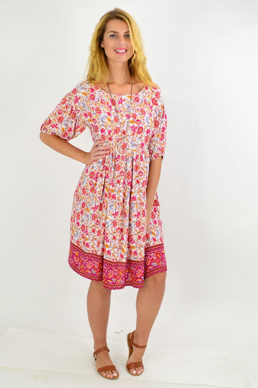 Pink floral puff sleeve tunic dress by Indigo Designs, featuring a flowy silhouette and vibrant floral pattern.