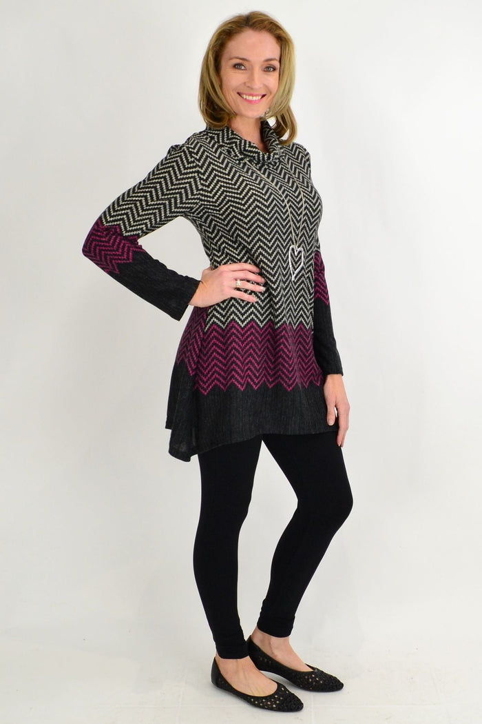 Black zigzag patterned winter tunic by Whispers, featuring a pink roll neck and cozy, fashionable design for cold weather.