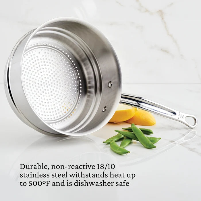 Stainless steel Steamer on a white background with a lid on a marble surface with vegetables.