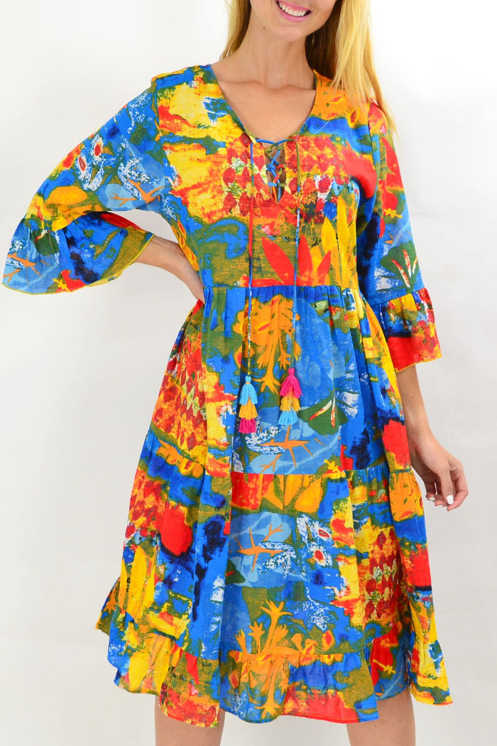 Colorful Rainbow Lily tiered tunic dress from Wishstone, featuring flowing fabric and vibrant rainbow pattern.