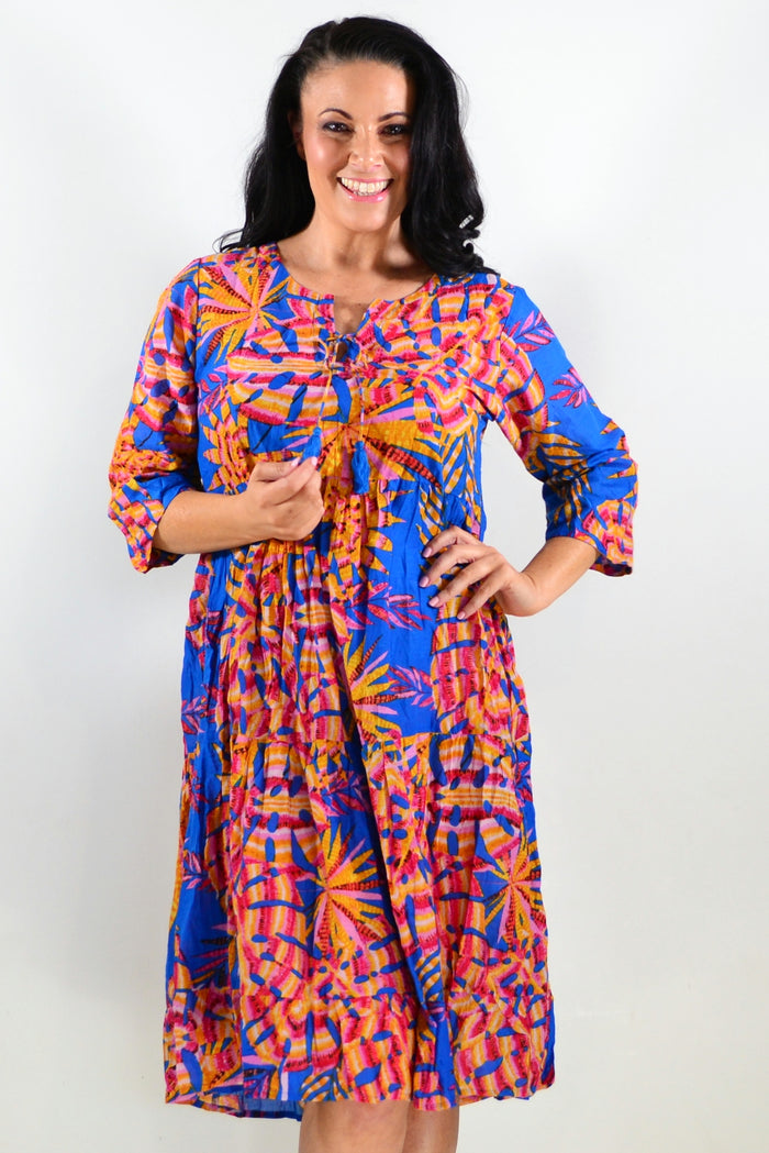 Rebecca Blue Tie Neck Tunic Dress by One Summer, stylish blue tunic with a tie neckline, displayed on a hanger against a neutral background.