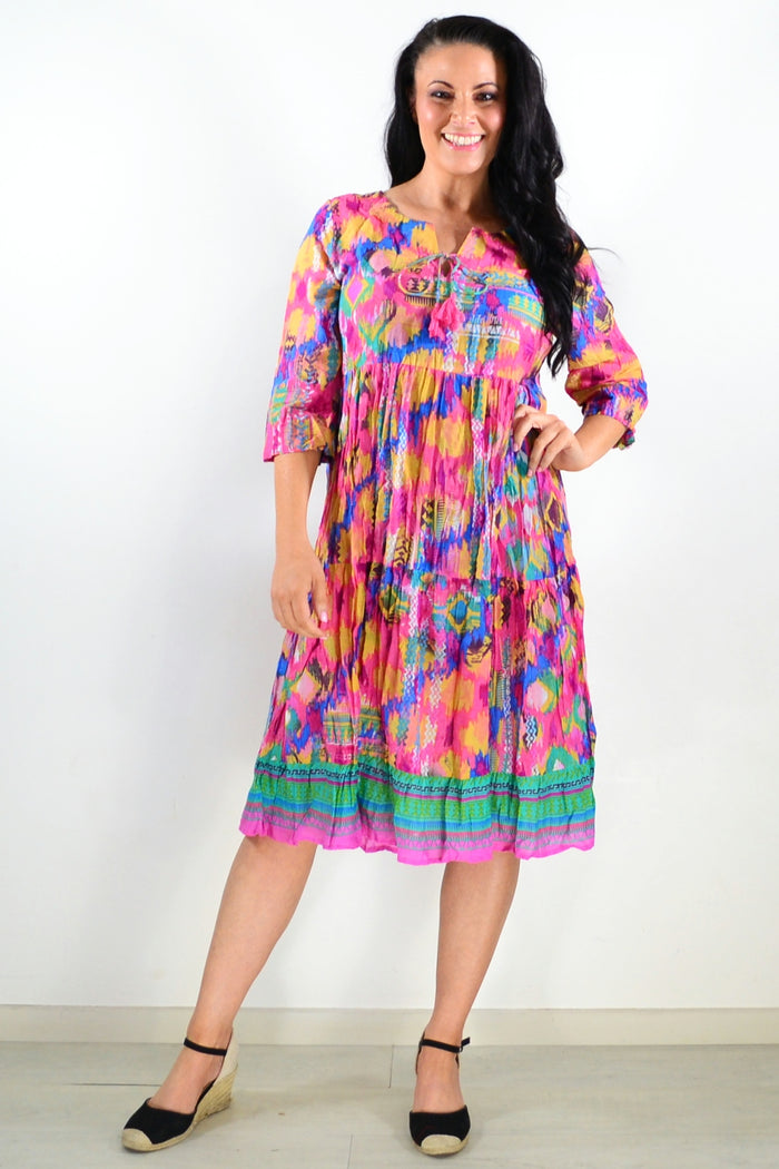 Rebecca Holi Tie Neck Tunic Dress by One Summer, featuring a flowing silhouette and tie neckline, displayed on a model.