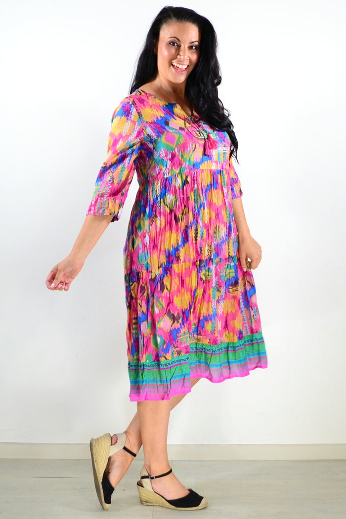 Rebecca Holi tie-neck tunic dress by One Summer, featuring a flowy fabric and stylish tie-neck design, worn by a model.