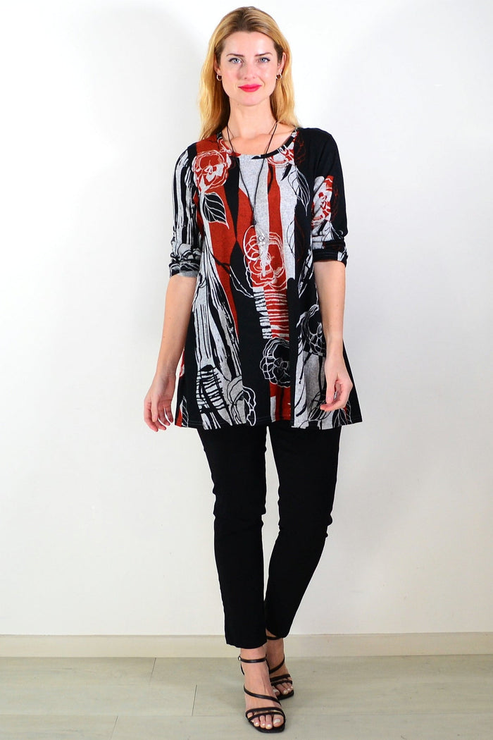 Red and grey floral print fleece tunic top by Hourglass, featuring a cozy, stylish design with a relaxed fit and vibrant floral pattern.