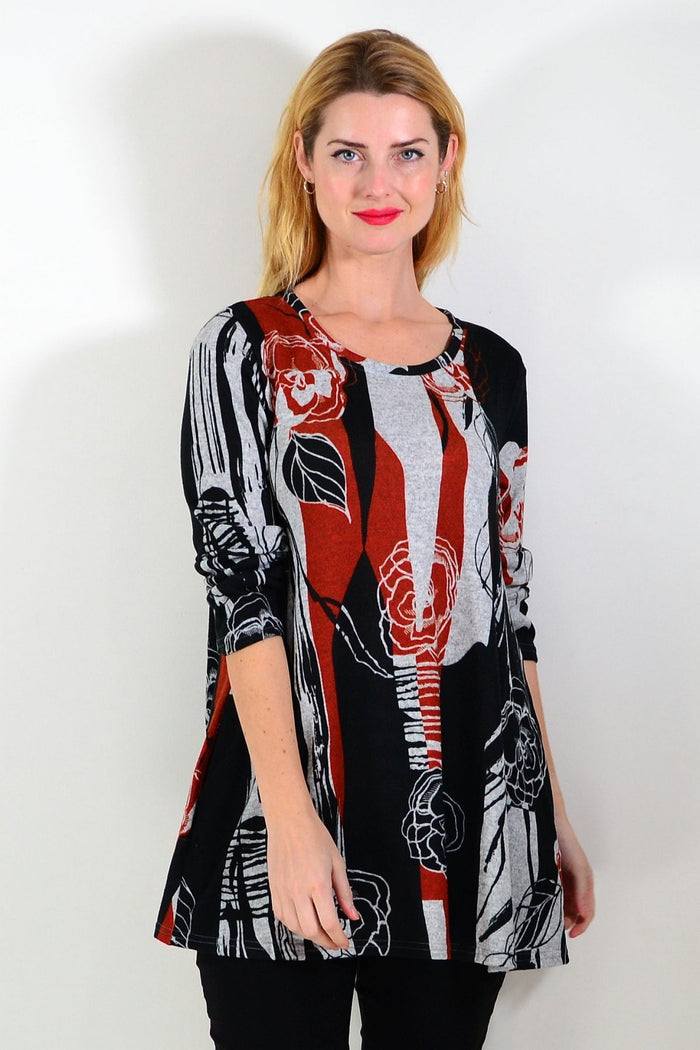 Red and grey floral print fleece tunic top by Hourglass, showcasing a cozy, stylish design with vibrant flower patterns.