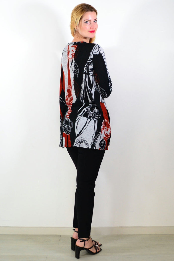 Red and grey floral print fleece tunic top by Hourglass, featuring a cozy, stylish design with a relaxed fit and vibrant pattern.