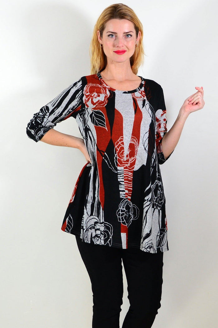 Red and grey floral print fleece tunic top by Hourglass, featuring a cozy, stylish design with a relaxed fit and vibrant pattern.