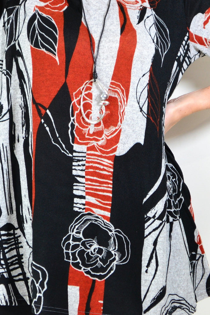 Red and grey floral print fleece tunic top by Hourglass, featuring a cozy design with vibrant floral patterns.