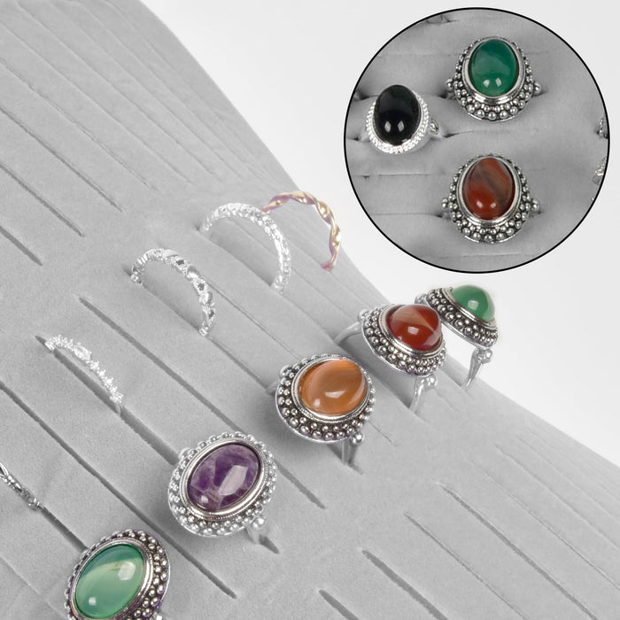 Rings and earrings displayed in the gray organizer's parallel jewelry slots