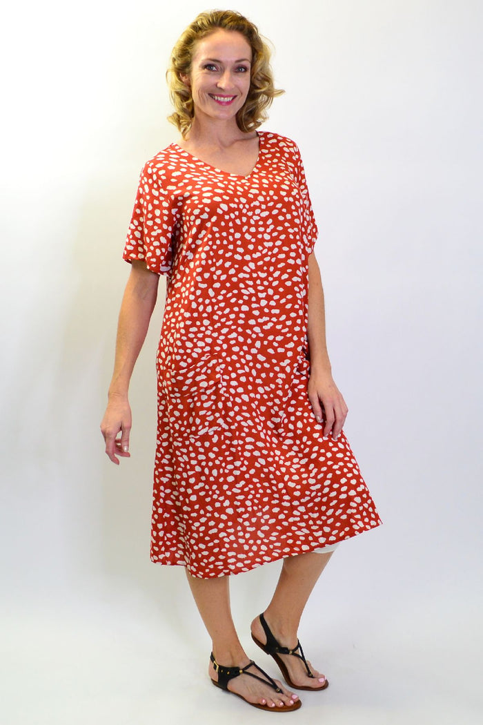 Sunshine Rust Dots and Pockets Tunic Slip Dress with sleeveless design and relaxed fit, featuring rust-colored dot pattern and front pockets.