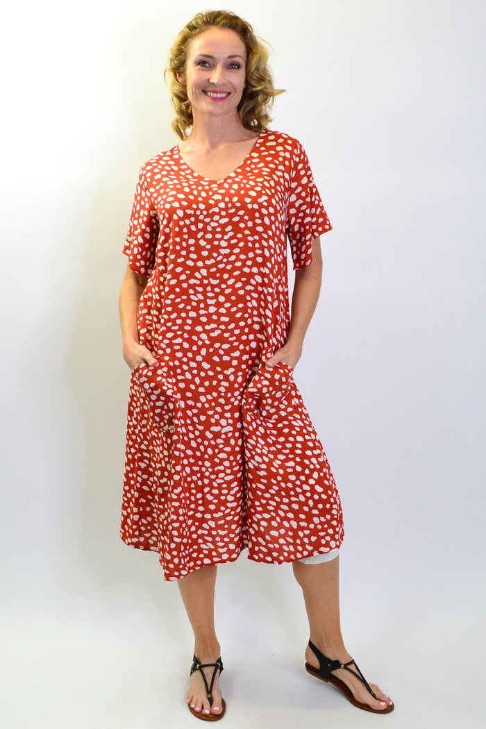 Sunshine rust dots and pockets tunic slip dress with a relaxed fit, featuring a V-neck, sleeveless design, and side pockets.
