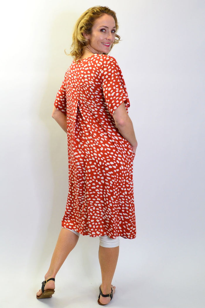 Sunshine rust dotted tunic slip dress with pockets, sleeveless design, lightweight fabric, and relaxed fit, perfect for casual wear.