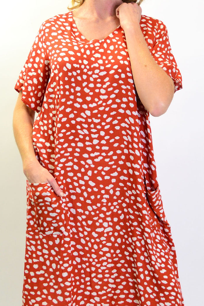 Sunshine Rust Dots and Pockets Tunic Slip Dress with long sleeves, featuring rust-colored dots and front pockets, casual and stylish.