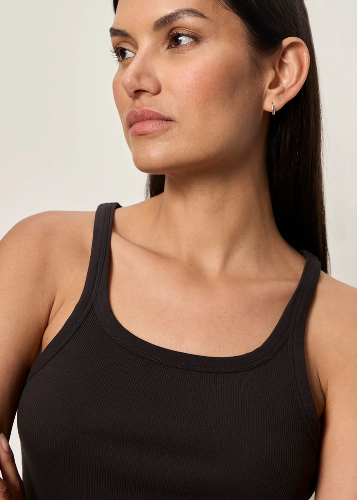 Close up of a woman wearing a black tank top