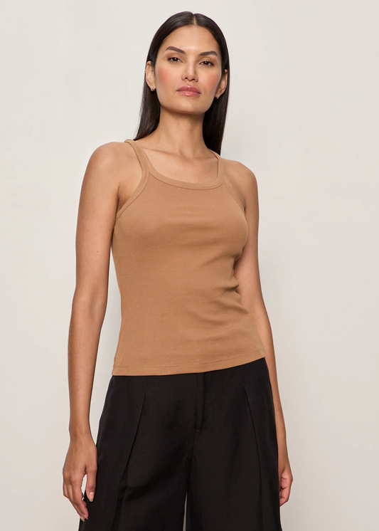 Woman wearing a brown tank top with black bottoms