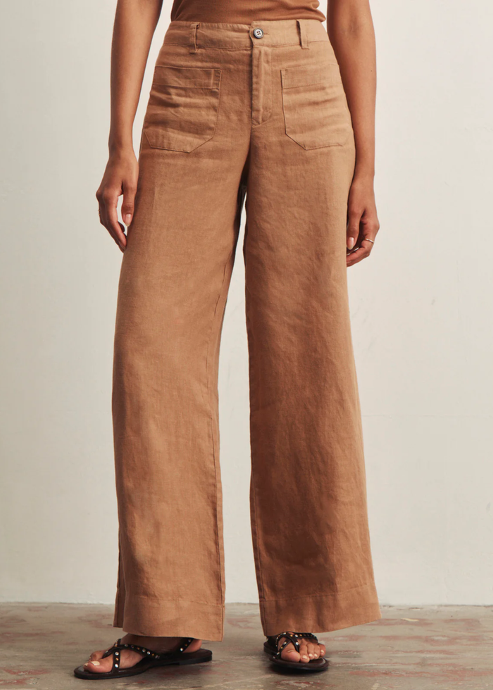 Woman wearing brown wide leg pants with a brown tank top