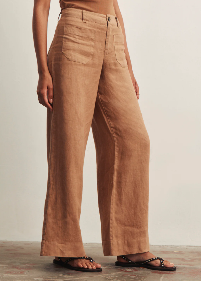 Woman wearing brown wide leg pants with a brown tank top