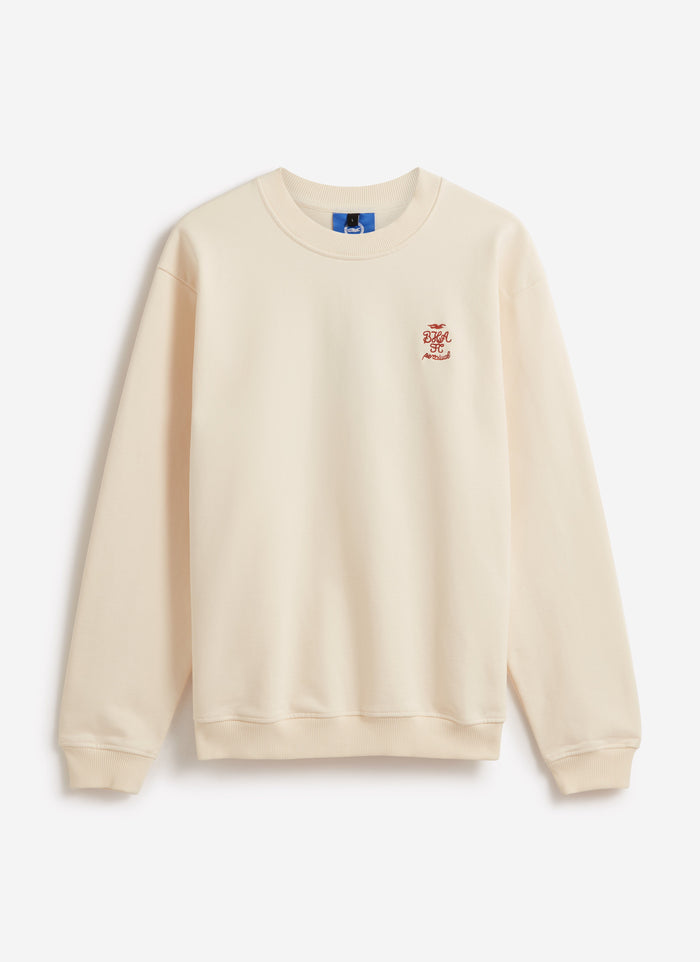 Front view of the cream Percival x Brighton & Hove Albion F.C. sweatshirt, showing the red chest crest embroidery.