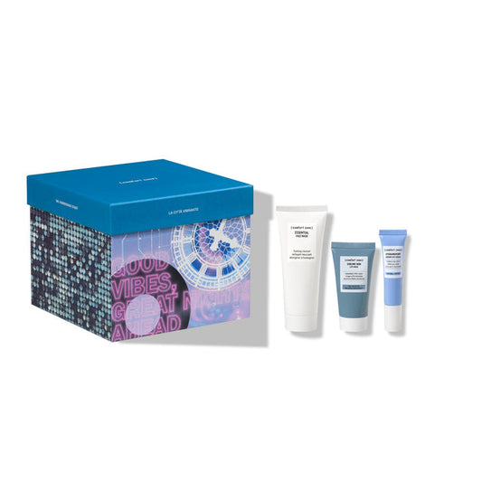 The Bustling City Kit | [ comfort zone ] featuring three skincare products next to a decorative blue and purple box with city-themed graphics and motivational text.