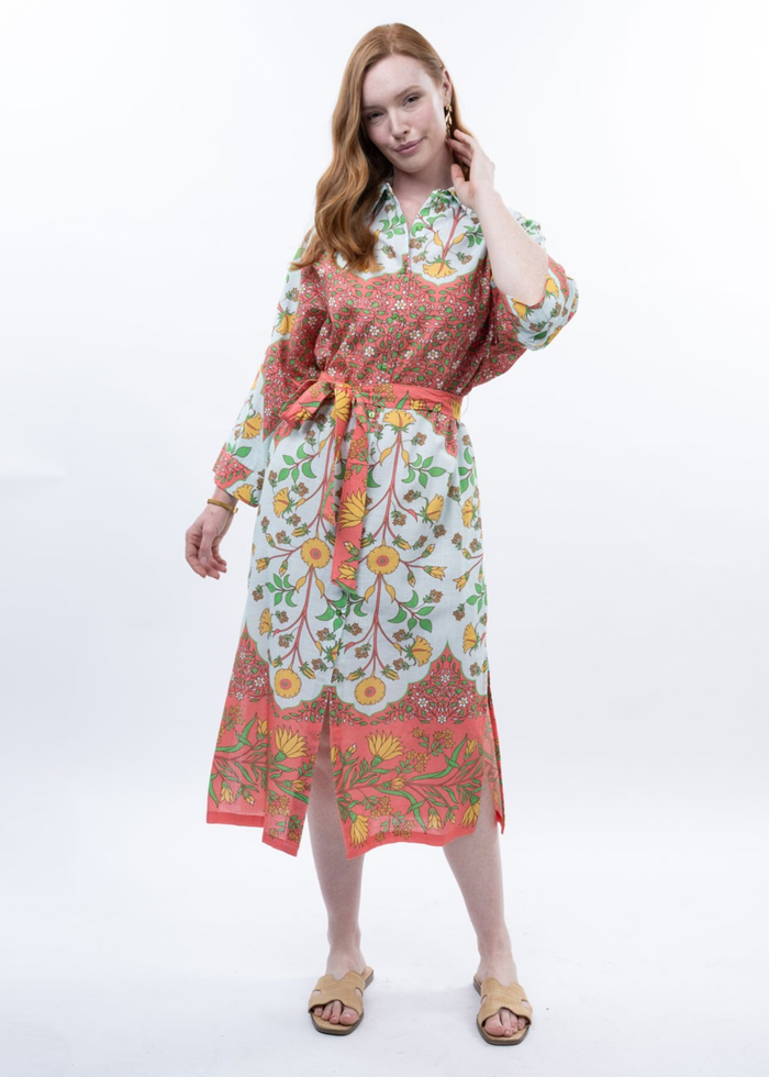 Woman wearing a multicolor floral midi dress with sandals