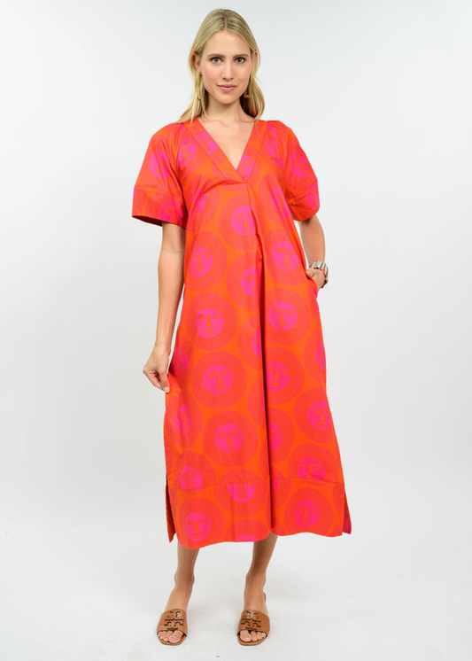 Woman wearing a hot pink and orange midi dress with sandals