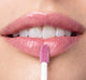 Close-up of lips applying Vitamin Glaze® Oil Infused Lip Gloss – Violet Orchid | Farmhouse Fresh, showcasing a smooth, glossy finish with a sheer violet orchid tint.