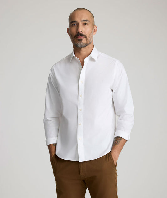 Model is wearing UNTUCKit Arden wrinkle-free shirt in white.