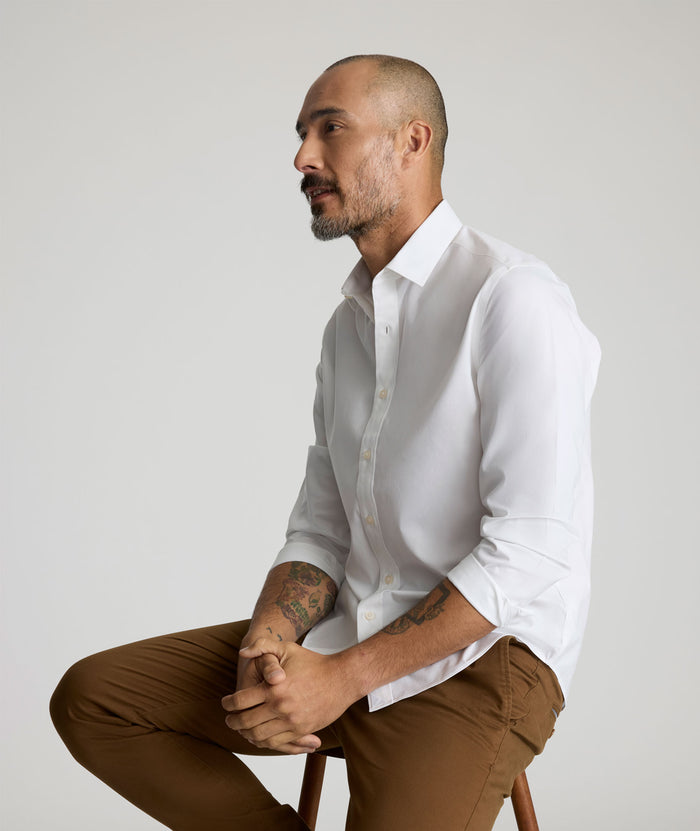Model is wearing UNTUCKit Arden wrinkle-free shirt in white.