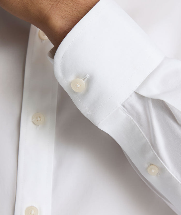 Model is wearing UNTUCKit Arden wrinkle-free shirt in white.