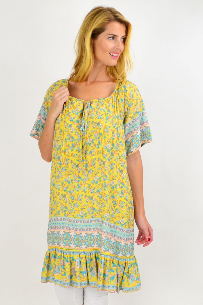 Yellow floral flowy tunic top by New U Collection, featuring lightweight fabric and a relaxed fit with vibrant floral pattern.
