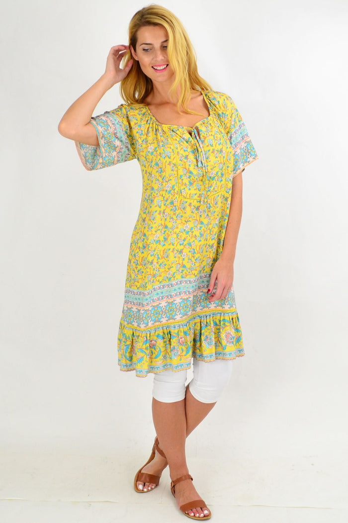 Yellow floral flowy tunic top from New U Collection, featuring a relaxed fit and vibrant floral print.