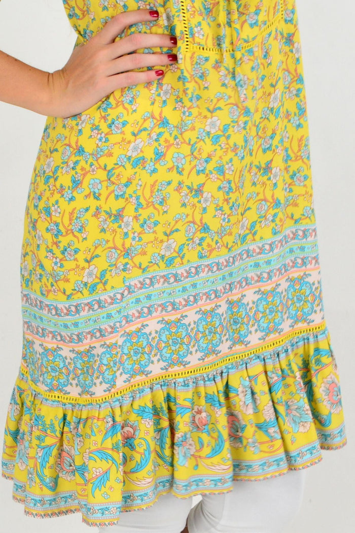 Yellow floral flowy tunic top from New U Collection featuring a relaxed fit and vibrant flower pattern.